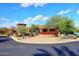 Desert home with circular driveway, lush landscaping, and gorgeous stone work at 9115 N 101St Way, Scottsdale, AZ 85258
