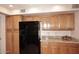 Charming kitchen featuring oak cabinets and black appliances at 9115 N 101St Way, Scottsdale, AZ 85258