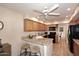 Charming kitchen features granite countertops, oak cabinets, black appliances and tiled floors at 9115 N 101St Way, Scottsdale, AZ 85258