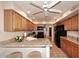 Charming kitchen features granite countertops, oak cabinets, black appliances and tiled floors at 9115 N 101St Way, Scottsdale, AZ 85258