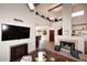 Open-concept living area with tile flooring, fireplace, vaulted ceilings and lots of natural light at 9115 N 101St Way, Scottsdale, AZ 85258