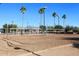 Outdoor sand volleyball court on community grounds with mature palm trees at 9115 N 101St Way, Scottsdale, AZ 85258