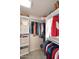 Walk-in closet featuring custom shelving, rods, and ample storage space; everything in its place at 9115 N 101St Way, Scottsdale, AZ 85258