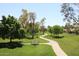 A winding walking path meanders through the manicured green space at 9115 N 101St Way, Scottsdale, AZ 85258