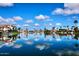 Tranquil lake scene with boats docked in front of beautiful waterfront homes under a sunny sky at 9115 N 101St Way, Scottsdale, AZ 85258
