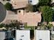 Aerial view of a home with a private yard, red tile roof and mature landscaping at 9224 E Windrose Dr, Scottsdale, AZ 85260
