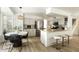 Modern kitchen with stainless steel appliances, granite island, and eat-in dining area at 9224 E Windrose Dr, Scottsdale, AZ 85260