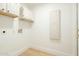 Laundry room with ample cabinet space and modern flooring at 9224 E Windrose Dr, Scottsdale, AZ 85260