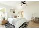 Bright primary bedroom features a ceiling fan, decor, and neutral color pallet at 9224 E Windrose Dr, Scottsdale, AZ 85260