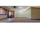 Bright living room with carpet and tile flooring and French doors, offering versatility and style at 949 N Ricardo N Cir, Mesa, AZ 85205
