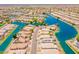 Wide aerial view of a neighborhood on a lake with mature trees and desert landscaping at 10526 W Tonopah Dr, Peoria, AZ 85382