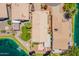 Birds eye view of a home featuring desert landscaping, mature trees, and lake views at 10526 W Tonopah Dr, Peoria, AZ 85382