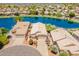 Scenic aerial view of homes on a lake featuring mature trees and desert landscaping at 10526 W Tonopah Dr, Peoria, AZ 85382