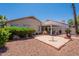 Landscaped backyard featuring a covered patio, desert landscape, and outdoor living space at 10526 W Tonopah Dr, Peoria, AZ 85382