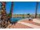 Beautiful backyard featuring palm trees and a serene lake view, perfect for relaxing at 10526 W Tonopah Dr, Peoria, AZ 85382