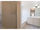 Bathroom featuring a glass shower, soaking tub, and white vanity at 10526 W Tonopah Dr, Peoria, AZ 85382