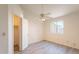 Bright bedroom features a ceiling fan, neutral walls and modern gray flooring at 10526 W Tonopah Dr, Peoria, AZ 85382