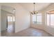 Dining area with a chandelier, tile floor, and bright window at 10526 W Tonopah Dr, Peoria, AZ 85382