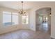 Bright dining room with decorative chandelier, tile flooring, and ample natural light at 10526 W Tonopah Dr, Peoria, AZ 85382
