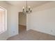 Dining room with decorative light fixture and neutral tile flooring at 10526 W Tonopah Dr, Peoria, AZ 85382