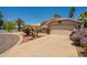 Front exterior of a home on a corner lot next to a lake and featuring desert landscaping at 10526 W Tonopah Dr, Peoria, AZ 85382