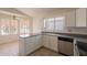 Bright kitchen features stainless steel appliances, white cabinets, and breakfast nook at 10526 W Tonopah Dr, Peoria, AZ 85382