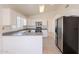 Open kitchen featuring stainless steel appliances, modern cabinetry, and tile flooring at 10526 W Tonopah Dr, Peoria, AZ 85382