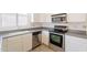 Kitchen with stainless steel appliances, gray countertops, and tile floors at 10526 W Tonopah Dr, Peoria, AZ 85382