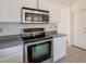 Kitchen features stainless steel appliances, white cabinets, and neutral countertop at 10526 W Tonopah Dr, Peoria, AZ 85382