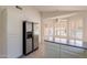 Bright kitchen features stainless steel appliances, white cabinets, and sunlit breakfast nook at 10526 W Tonopah Dr, Peoria, AZ 85382
