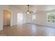 Spacious living room with tile floors, archway, ceiling fan, and a window at 10526 W Tonopah Dr, Peoria, AZ 85382