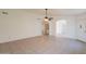 Open-concept living room featuring tile floors, arched doorways, and ample natural light at 10526 W Tonopah Dr, Peoria, AZ 85382
