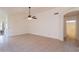 Bright and airy living room with tile flooring, ceiling fan, and neutral walls at 10526 W Tonopah Dr, Peoria, AZ 85382