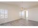 Spacious main bedroom featuring vaulted ceilings, a ceiling fan, and view to an en suite bathroom at 10526 W Tonopah Dr, Peoria, AZ 85382