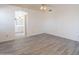 Bright main bedroom featuring a ceiling fan, with view to an en suite bathroom at 10526 W Tonopah Dr, Peoria, AZ 85382