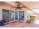 Cozy covered patio featuring a ceiling fan, decorative tile flooring, and easy access via sliding glass doors at 10526 W Tonopah Dr, Peoria, AZ 85382