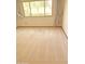 A bedroom with a large window letting in natural light and beige carpeting at 10647 W Campana Dr, Sun City, AZ 85351