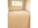 A bedroom with a large window letting in natural light and beige carpeting at 10647 W Campana Dr, Sun City, AZ 85351