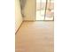 A bedroom with a sliding glass door leading to a patio and beige carpeting at 10647 W Campana Dr, Sun City, AZ 85351
