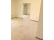 Open-concept living room with neutral walls and carpet flooring, leading to adjacent rooms at 10647 W Campana Dr, Sun City, AZ 85351
