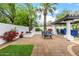 Backyard patio area with lush greenery and a shaded seating space at 10662 E Carol Ave, Scottsdale, AZ 85258