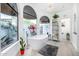 Bright and airy bathroom with a freestanding tub, complemented by natural light from large windows and stylish decor accents at 10662 E Carol Ave, Scottsdale, AZ 85258