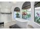 Luxurious bathroom with a freestanding tub, walk-in shower, and serene outdoor views through expansive arched windows at 10662 E Carol Ave, Scottsdale, AZ 85258