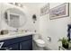 Chic bathroom with navy blue vanity, quartz countertop, stylish mirror, and decorative art for a modern touch at 10662 E Carol Ave, Scottsdale, AZ 85258