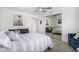Bedroom with gray carpet, a ceiling fan, single bed, blue sofa and mirrored closet doors at 10662 E Carol Ave, Scottsdale, AZ 85258