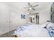 Bright bedroom with soft carpet, bed with floral bedding, and a view through an open doorway to the entry at 10662 E Carol Ave, Scottsdale, AZ 85258