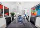 An elegant dining room features stylish décor, bright artwork, and a modern chandelier at 10662 E Carol Ave, Scottsdale, AZ 85258