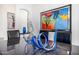 Close up of an elegant dining room table with decorative centerpiece, modern artwork, and an arched doorway at 10662 E Carol Ave, Scottsdale, AZ 85258