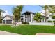 Stunning two-story home featuring lush landscaping, a decorative fountain, and a charming architectural design at 10662 E Carol Ave, Scottsdale, AZ 85258