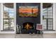 Close up of a fireplace with a mounted television and bright windows at 10662 E Carol Ave, Scottsdale, AZ 85258